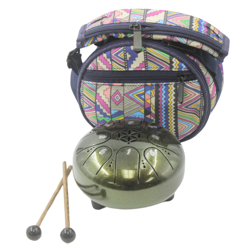 Green metal tongue drum with patterned carrying case and mallets on a white background