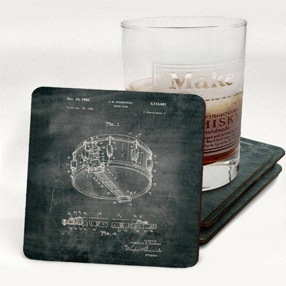 Coasters with a technical drawing of a snare drum on a chalkboard background