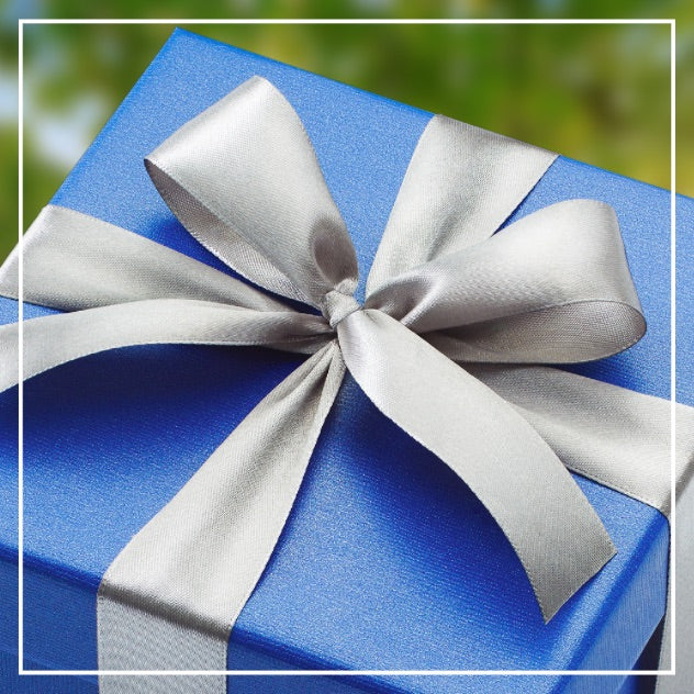 Close-up of a present wrapped in dark blue paper and a silver bow