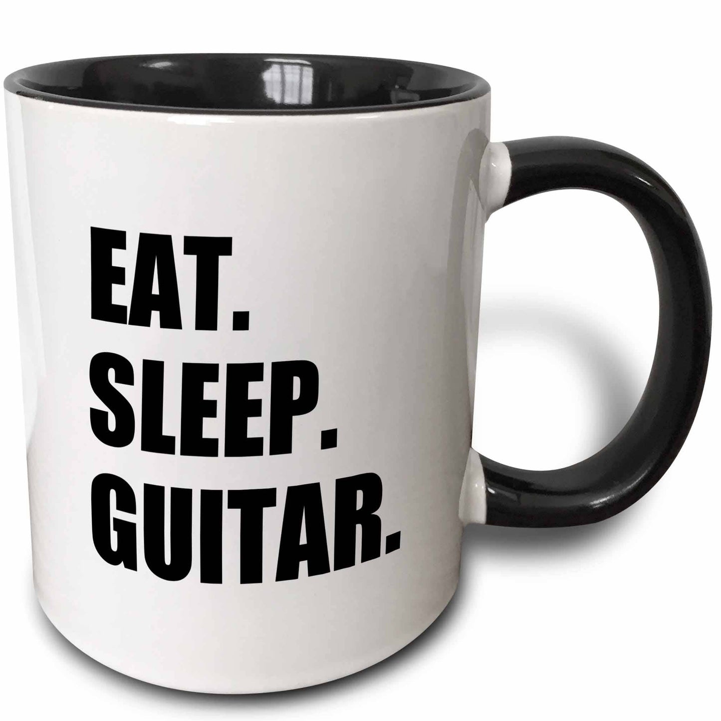White mug with black interior and handle, featuring 'Eat. Sleep. Guitar.' text.