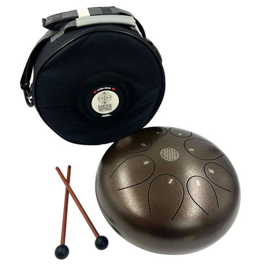Brown tongue drum with carrying case and sticks on a white background