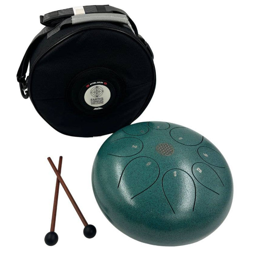 Green tongue drum with black carrying case and drumsticks on a white background
