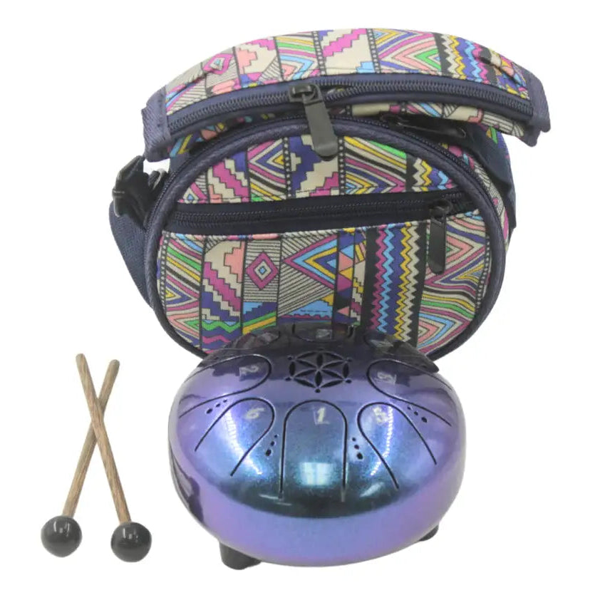Metal tongue drum with patterned carrying bag and mallets on a white background